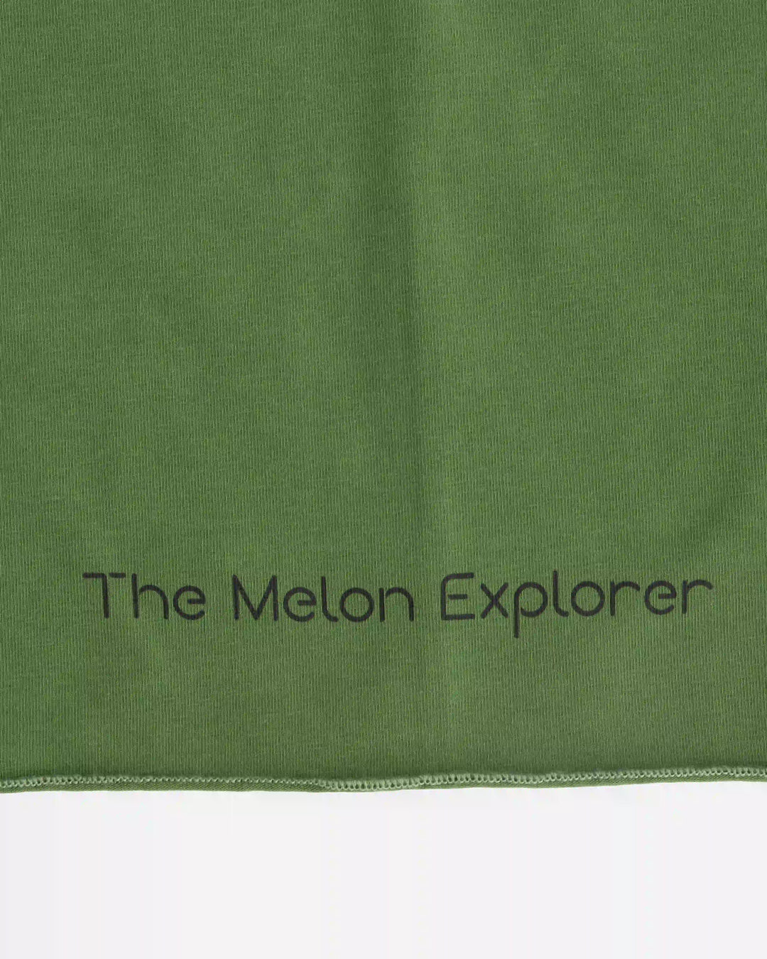 Close-up of brand logo on green organic cotton tubular scarf (neck warmer) from the Woods collection