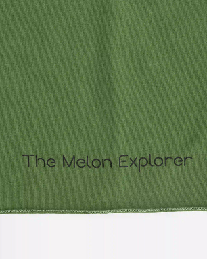 Close-up of brand logo on green organic cotton tubular scarf (neck warmer) from the Woods collection