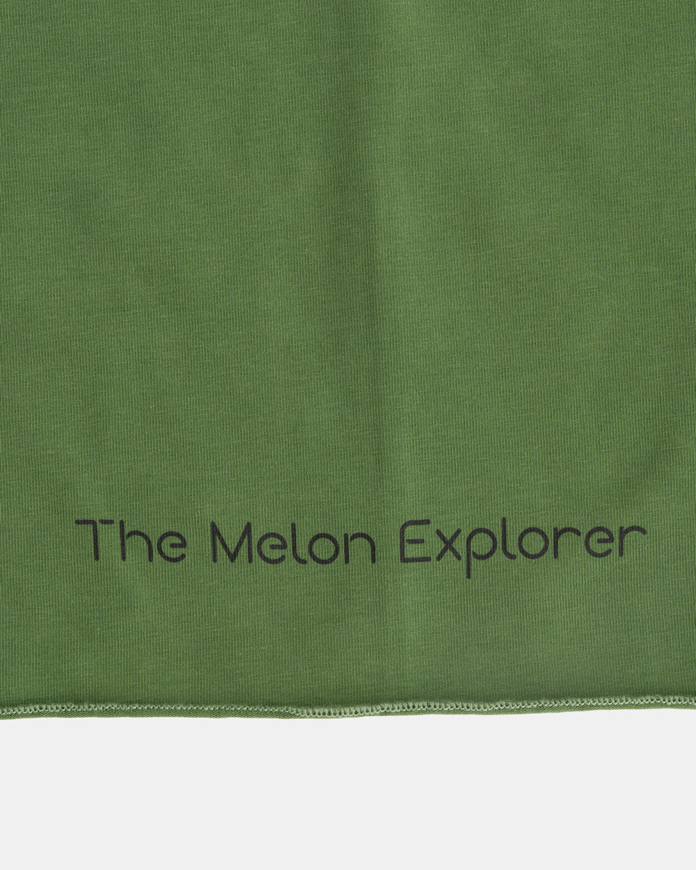 Detail of organic cotton tubular scarf from the Woods collection in green with brand - The Melon Explorer