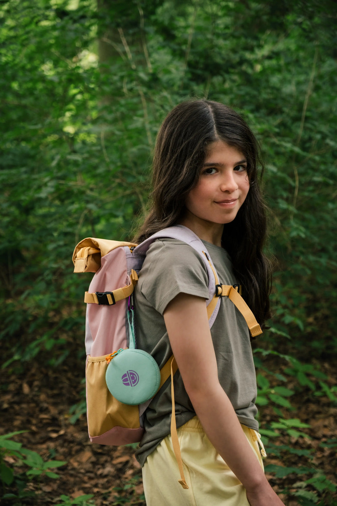 Happy girl wearing a Maju recycled polyester backpack in the park