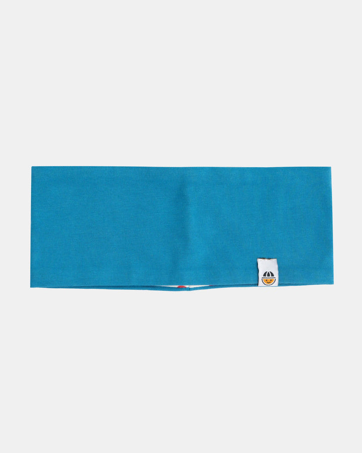 Reversible organic cotton headband from the Breeze collection in blue with patterned lining, side view