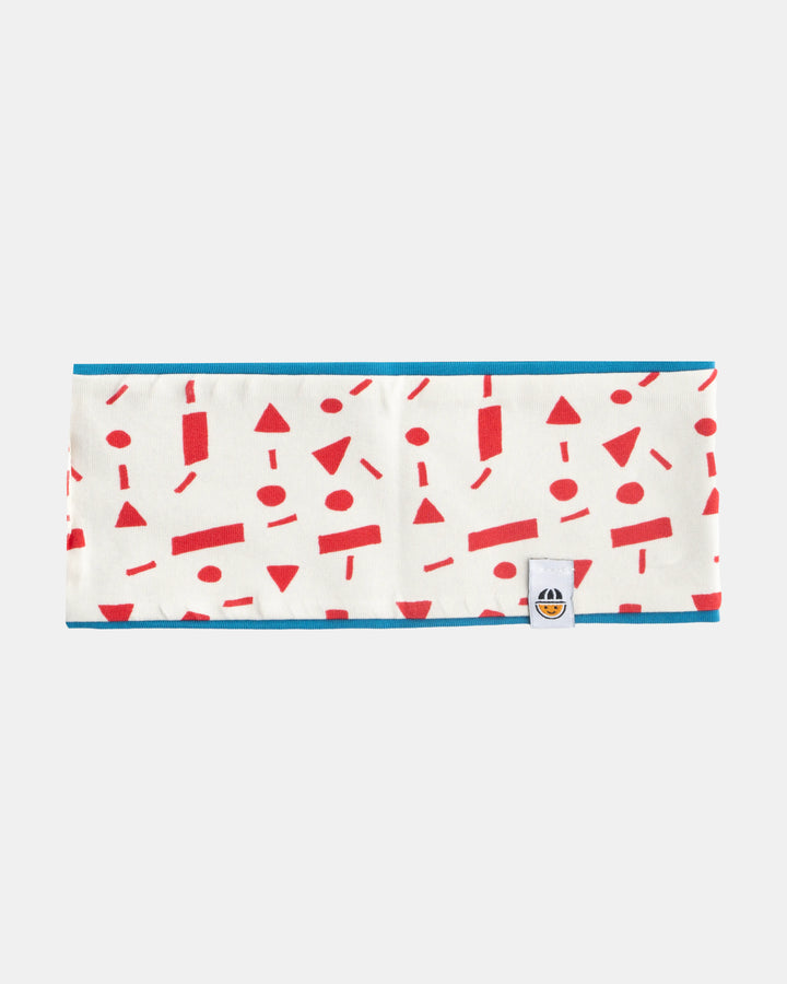Reversible organic cotton headband from the Breeze collection in red pattern and blue, flat lay front view